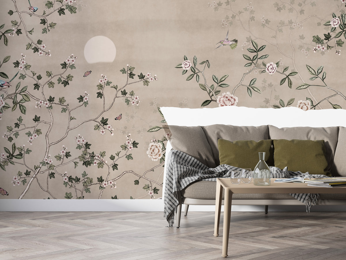 Chinoiserie Floral Botanical wallpaper mural with roses and hummingbird behind a beige sofa with olive cushions