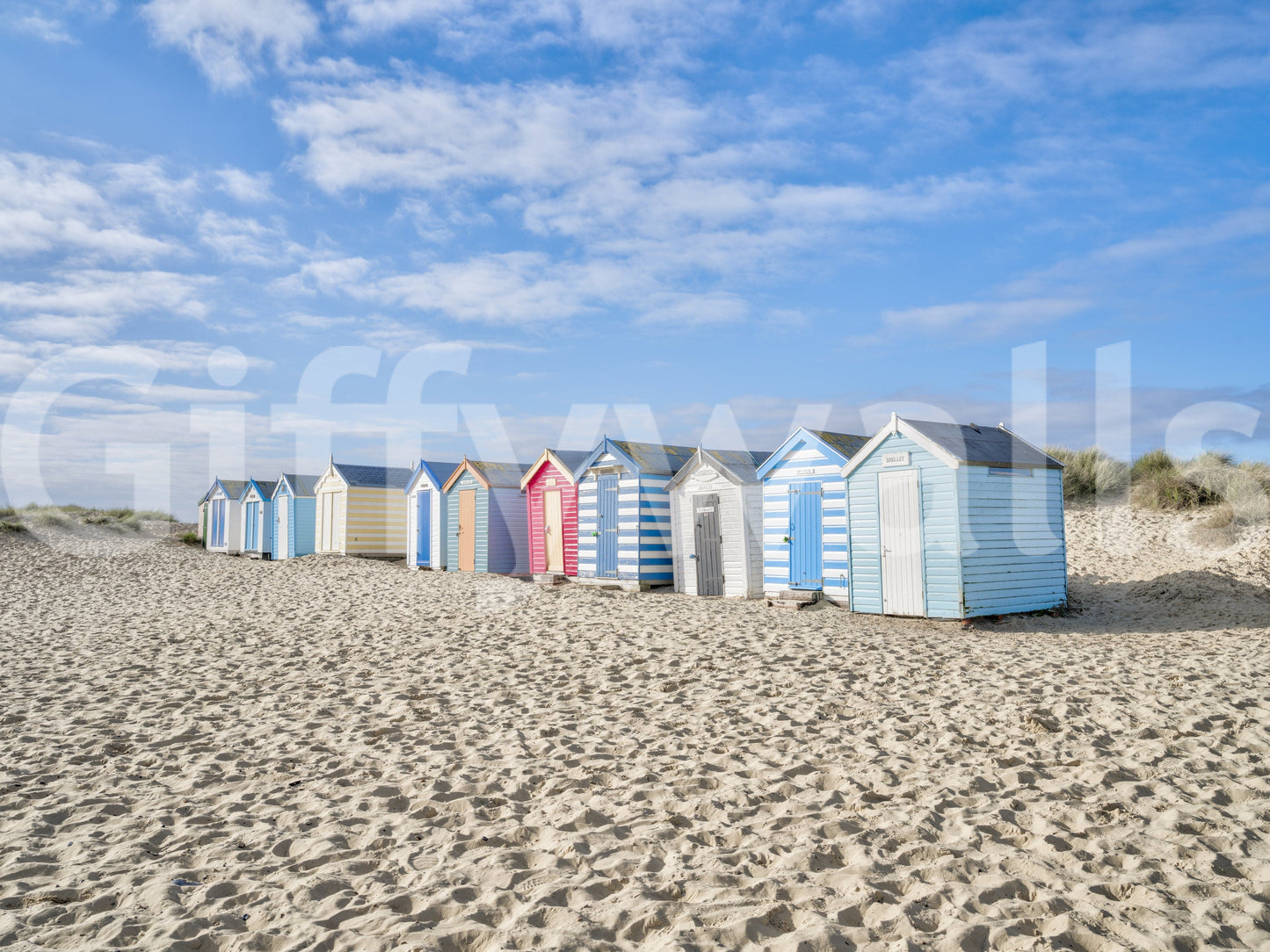A detail of the warm tones in the beach huts and sky.