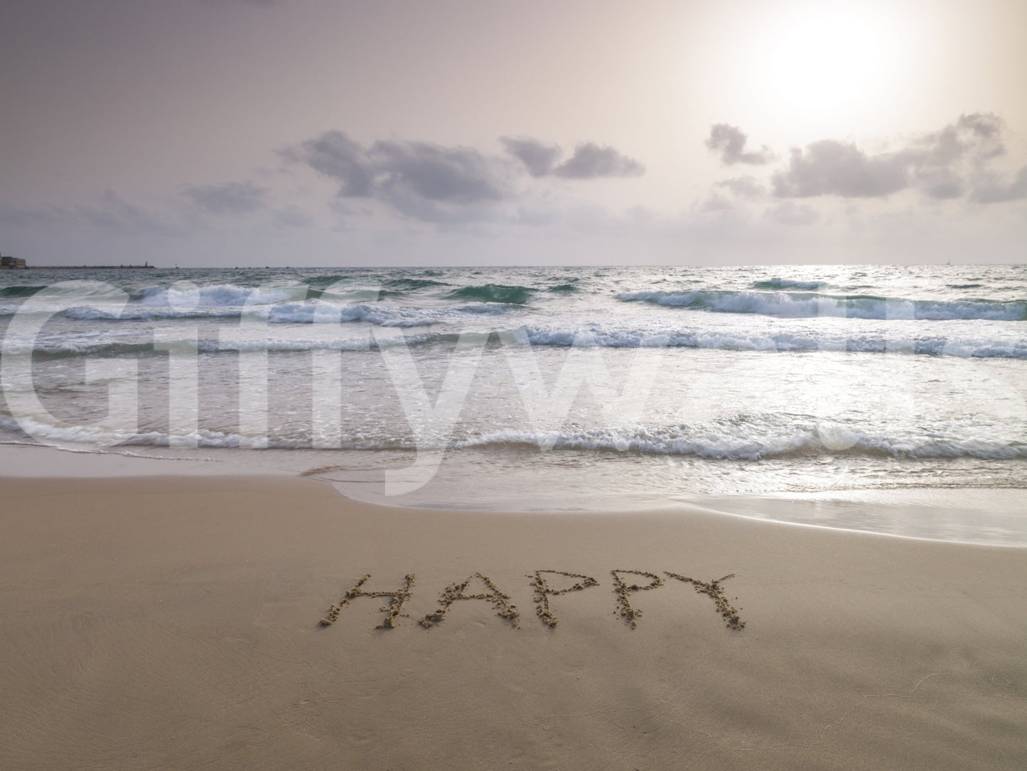 Happy Beach Vibes wallpaper mural shown full-wall, a dusk beach with HAPPY written in the sand and rolling waves