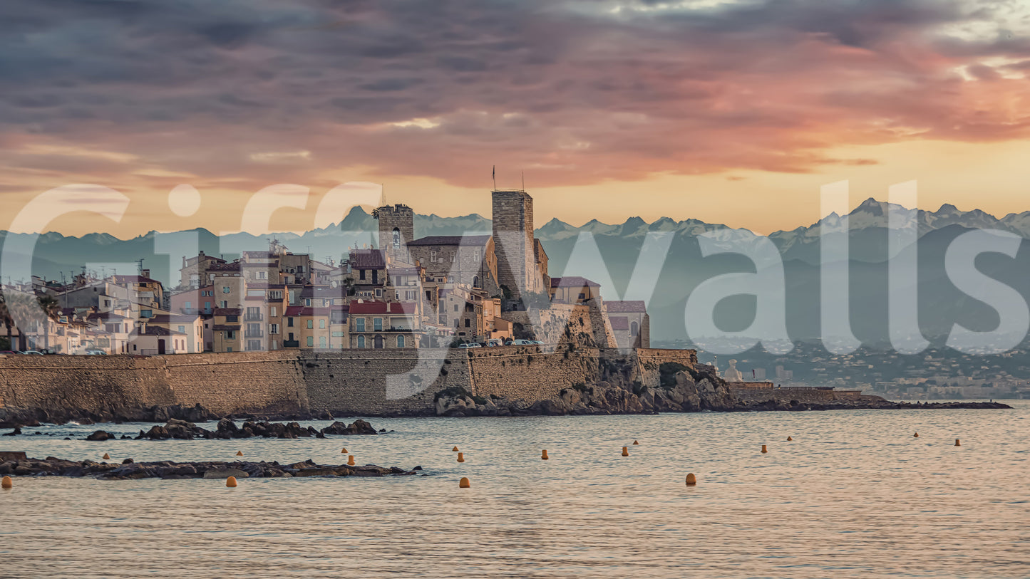 Dusk mural showing Antibes’ old port, stone ramparts, and glowing sunset clouds.