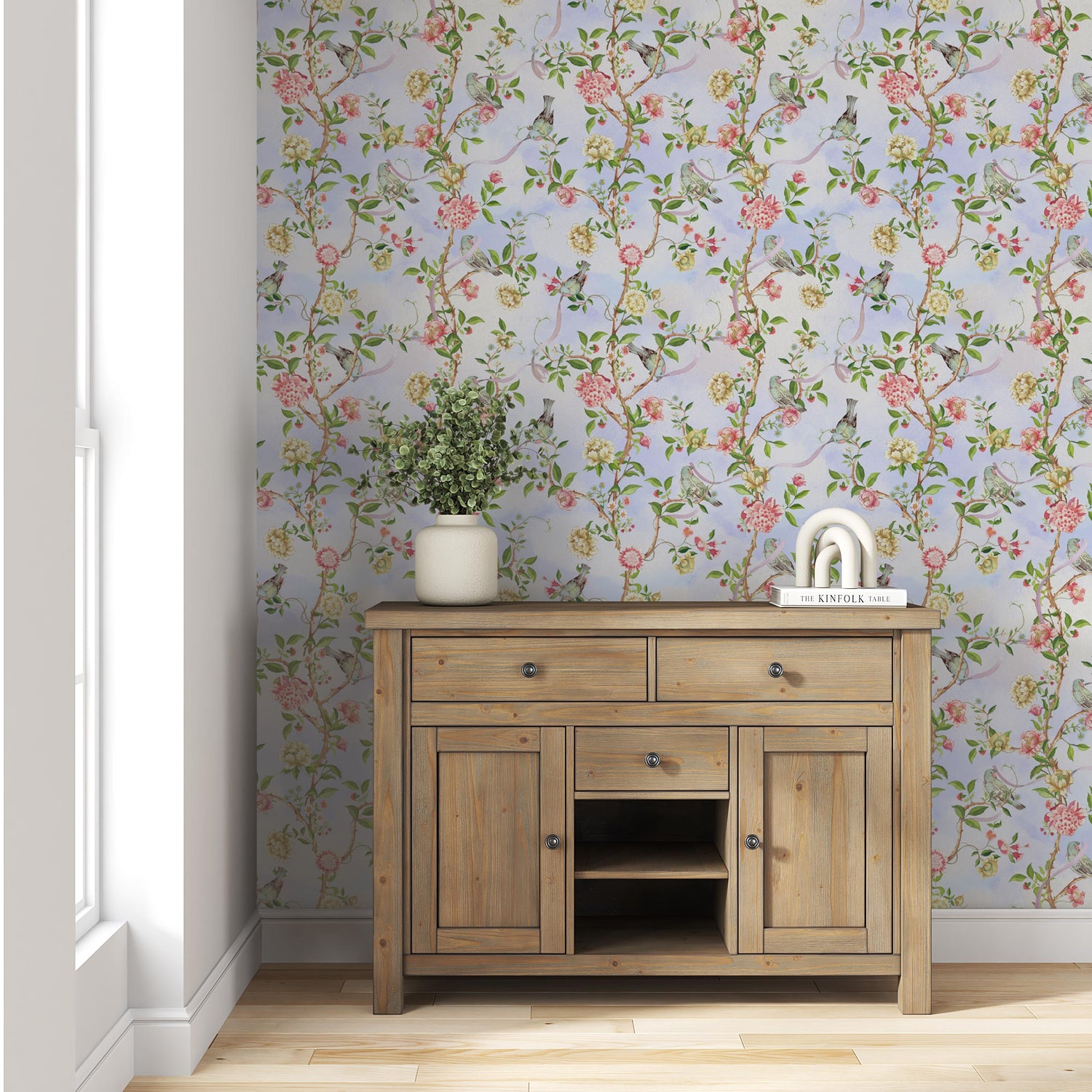 An elegant entrance hall featuring a rich, green botanical print hallway wallpaper with dark wood flooring.
