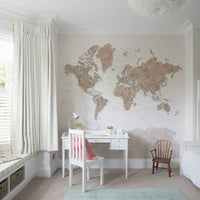 Vintage world map wallpaper in soft browns and blues

