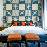 Minimalist indigo wallpaper with starburst quilt design

