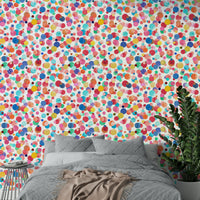Wallpaper featuring hand-painted watercolor dots in mixed hues.

