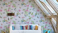 Enchanted Garden Escape Wallpaper with birds and blooming branches.

