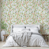 Gentle floral wallpaper with light tones and painted garden scenes.

