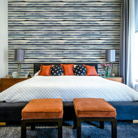 Wallpaper featuring soft blue and white watercolor stripes.

