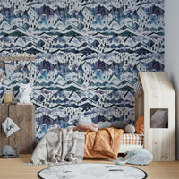 Hand-painted mountain wallpaper in cool blue and dusty mauve.

