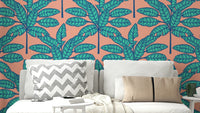 Tropical oasis wallpaper featuring desert leaves in soothing blue and soft pink.

