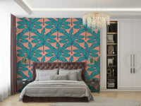 Wallpaper with bold tropical leaves in calming aqua and clay pink hues.

