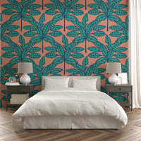 Mid-century modern wallpaper with tropical foliage in pastel aqua and clay pink.

