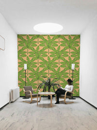Bright and bold tropical leaves design in green and orange tones on wallpaper.

