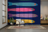 Playful wall mural featuring rainbow-colored fish on a royal blue background.

