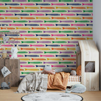 Rainbow-colored fish design on cream wallpaper for children’s rooms.

