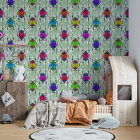 Nursery styled with Rainbow Bugs green wallpaper

