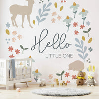 Whimsical "Hello Little One" woodland mural with calm designs.

