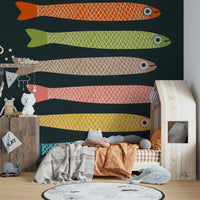 Colorful anchovies wall mural with dark charcoal background.

