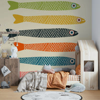 Cream background wall mural featuring playful multicolored fish.

