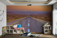 Desert highway at sunset captured in a wall mural with stretching lines.

