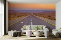 Serene desert highway wall mural with expansive views and soft sunset light.

