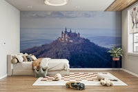 Hohenzollern Castle mural atop a forested mountain

