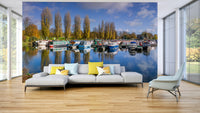 Wall mural of peaceful harbor scene with boats and trees


