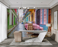 Vintage pink car parked on Havana street mural

