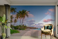 Tropical beach wall mural with soft pink clouds and blue sea.

