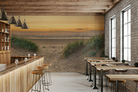 Peaceful beach mural featuring soft golden light and grassy dunes.


