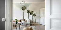 Retro-inspired wall mural of palm trees on a beach

