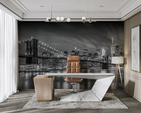 Cable detail of Brooklyn Bridge lit against New York skyline

