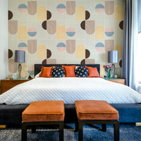 Living room accent wall showing abstract geometric wallpaper

