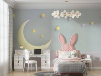 Gentle cloud shapes and moon over crib in wallpaper mural

