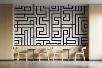 Black maze design on white backdrop
