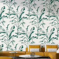 Wall mural with botanical leaves and vibrant greenery accents

