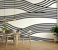 Elegant black-and-white wave patterns on a large mural.

