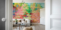 The wall mural is the main feature on a wall behind a gray sofa.

