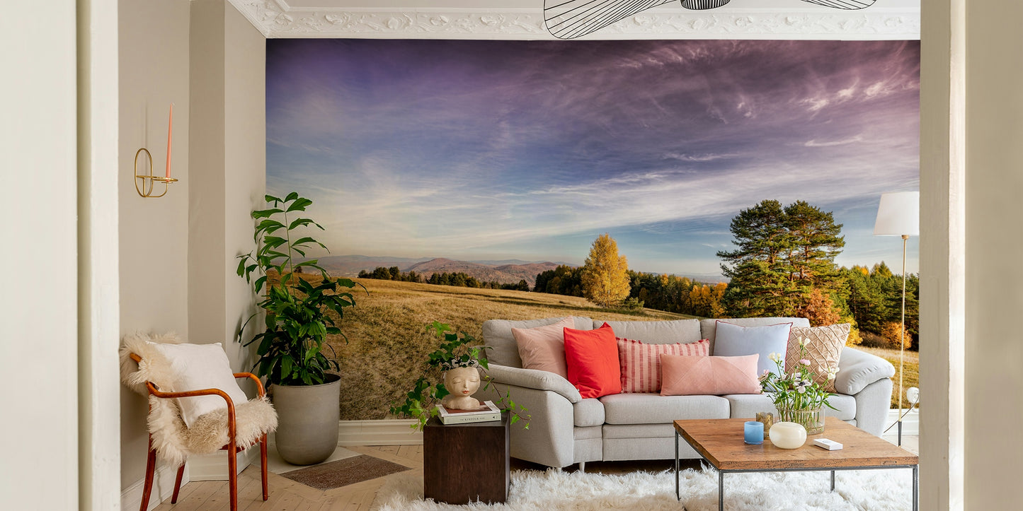 Distant trees with warm fall colors are visible at the edge of the field.

