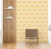 Stylized floral and leaf patterns in yellow, blue, and gray on a wall.

