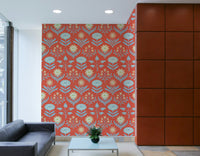 Stylized floral and leaf patterns in blue, cream, coral, and orange on a wall.

