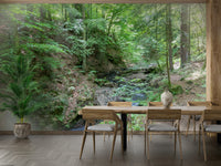 Lush green trees, ferns, and moss in a wall mural.

