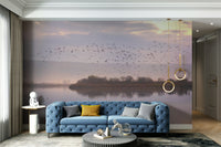 Features birds in graceful flight, silhouetted against a twilight or dusk sky.
