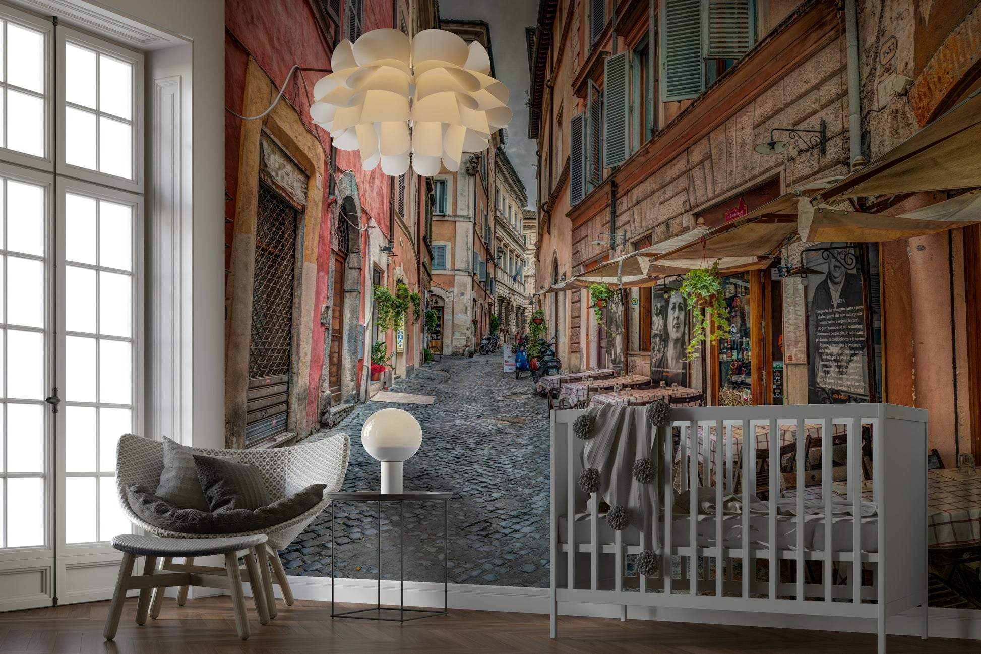 The image shows a small cafe with tables on a cobblestone street.

