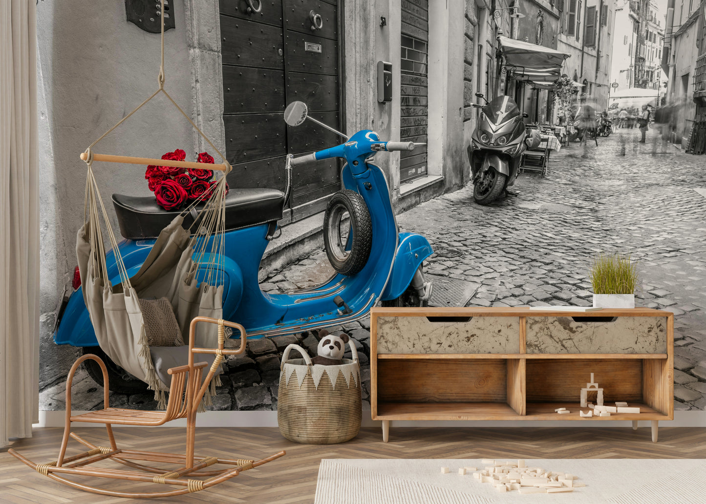 The scooter and red roses are in color, while the background is black and white.

