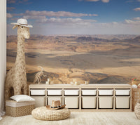 A wall mural with a panoramic desert scene.

