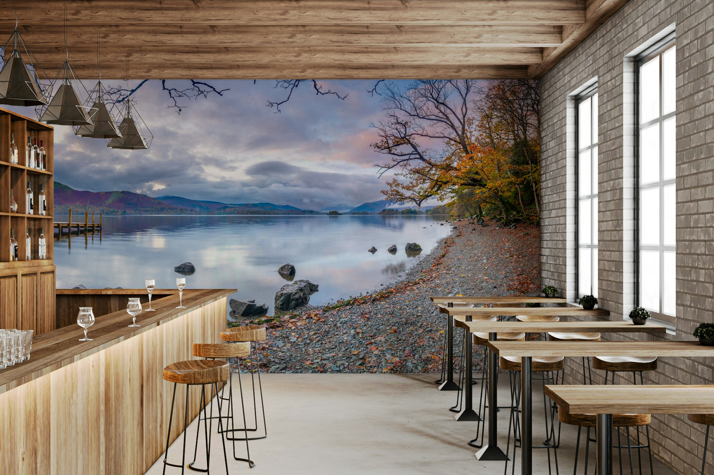 A wall mural of a serene lake surrounded by hills.

