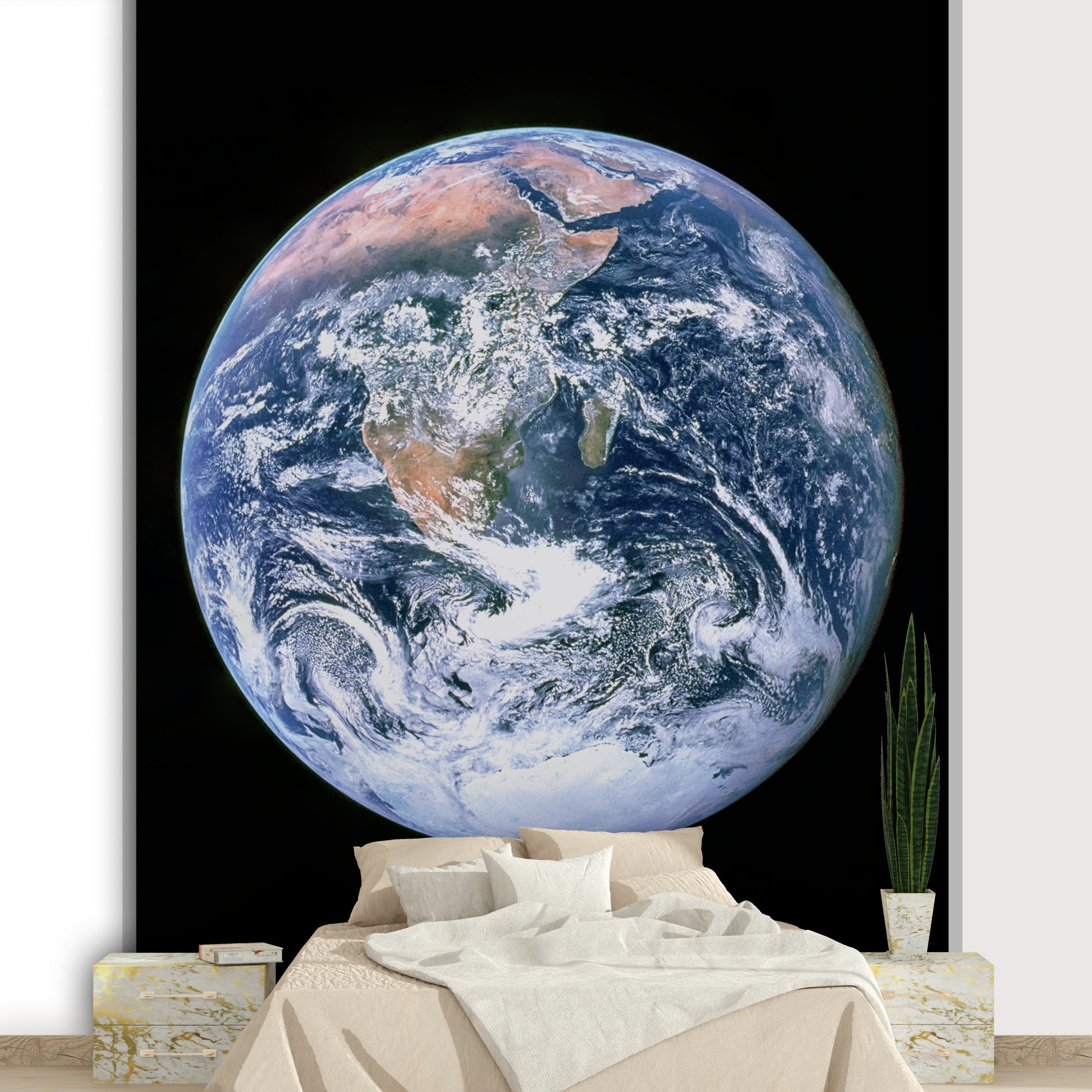 White, swirling clouds are scattered across the planet's surface.
