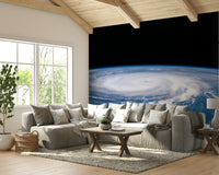 The colors are a mix of deep grays, blues, and black, with a bright white or yellow light in the center.
