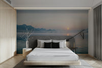 Soft, golden light from the rising sun filters through a gentle fog.
