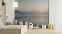A wide shot of a wall mural showing a sunrise over a misty landscape.
